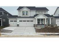 Charming two-story home boasts a three-car garage and modern farmhouse design at 7145 Firestone Rd, Whitestown, IN 46075