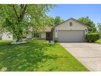 Charming single-story home featuring a well-maintained lawn, mature tree, and attached two-car garage at 7215 Wet Rock Ct, Indianapolis, IN 46236