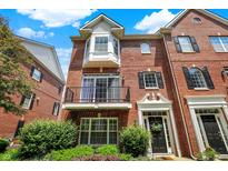 Beautiful brick townhouse with a balcony and well-maintained landscaping at 73 11Th Nw St, Carmel, IN 46032