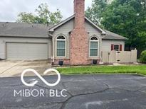 Charming home featuring a prominent brick chimney, arched windows, and attached two-car garage at 811 Gazebo Way, Greenwood, IN 46142