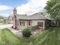 Inviting exterior view of the home featuring a well-manicured lawn and charming architectural details at 811 Gazebo Way, Greenwood, IN 46142