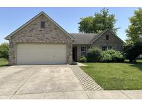 Charming brick home with attached garage and manicured lawn, offering curb appeal and functionality at 11014 Lake Run Dr, Fishers, IN 46038