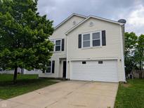 Two-story home with a two-car garage, tree in the yard, and vinyl siding at 11343 Congaree Way, Indianapolis, IN 46235