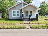 Charming home featuring a quaint front porch and neat landscaping at 1209 W 22Nd St, Anderson, IN 46016