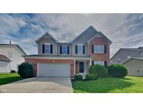 Charming two-story home with brick accents, well-kept landscaping, and a two-car garage at 1305 Gleneagle Dr, Indianapolis, IN 46239