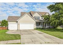 Charming two-story home with a well-maintained lawn and two-car garage under a partly cloudy sky at 1306 Flat Wood Ct, Brownsburg, IN 46112