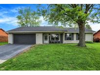 Charming single-story home featuring a well-manicured lawn, painted brick, and an attached garage at 200 Forum Dr, Whiteland, IN 46184