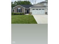 Charming home featuring a stone facade, dark shutters, and a two-car garage with lovely landscaping at 200 Mission Terrace Dr, Whiteland, IN 46184