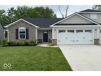 Charming single-story home featuring stone accents, a well-manicured lawn, and an attached two car garage at 200 Mission Terrace Dr, Whiteland, IN 46184