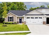 Charming home featuring stone accents, a well-manicured lawn, and an attached two car garage at 200 Mission Terrace Dr, Whiteland, IN 46184