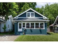 Charming two-story home featuring a blue exterior, bright windows, and a well-manicured lawn at 3934 N Kenwood Ave, Indianapolis, IN 46208