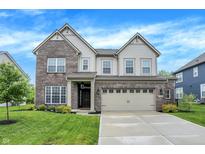 Charming two-story home featuring brick and siding, a two-car garage, and a well-manicured front yard at 4602 Hayward Way, Westfield, IN 46062