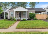 Charming single-story home boasts well-manicured lawn and inviting front porch at 5473 E 18Th St, Indianapolis, IN 46218