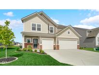 Charming two-story home featuring a three-car garage and well-manicured lawn at 7226 Sayers Rd, Indianapolis, IN 46259