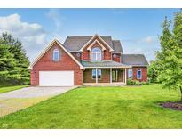 Beautiful two-story brick home featuring a well-manicured lawn and attached garage at 7333 State Road 42, Martinsville, IN 46151