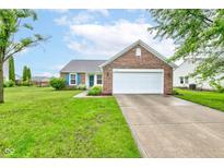Charming single-story brick home with a well-manicured lawn, blue shutters, and an attached two-car garage at 8684 Captain Dr, Avon, IN 46123