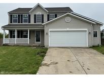 Charming two-story home with a covered porch, black shutters, and an attached two-car garage at 8939 Newchurch Blvd, Indianapolis, IN 46231