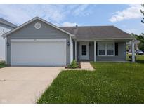 Charming single-story home with attached garage and well-maintained lawn at 901 Westpointe Dr, Shelbyville, IN 46176