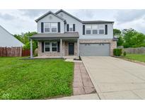 Charming two-story home with a well-maintained lawn, two car garage, and brick accents at 9206 Huntleigh Cir, Plainfield, IN 46168