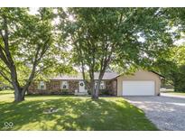 Charming brick ranch home with mature trees, well-manicured lawn and two car garage at 9390 N State Road 39, Lizton, IN 46149