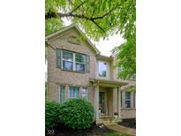 Charming brick home with covered porch, inviting entrance, and green shutters at 9705 Valley Springs Blvd, Fishers, IN 46037