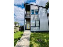 Contemporary two-story home with a modern design, gray siding, and a yellow front door at 1001 Harlan St, Indianapolis, IN 46203
