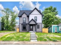 Charming two-story home with a beautifully landscaped yard and inviting exterior, perfect for modern living at 1027 Hosbrook St, Indianapolis, IN 46203