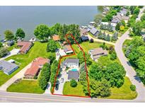 Stunning aerial view of lakefront property with pool, lush landscaping and ample parking at 1240 Stringtown Pike, Cicero, IN 46034