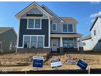 Two-story home with a mix of gray siding and brick accents under a clear blue sky in new construction neighborhood at 15360 Cardonia Rd, Fishers, IN 46037