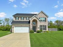 Charming two-story home with a well-manicured lawn and a two-car garage at 1843 Winchester Blvd, Avon, IN 46123