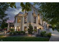 A luxurious home boasts manicured gardens and a charming outdoor design at 1894 Rhettsbury St, Carmel, IN 46032