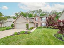 Charming two-story home with a two-car garage, brick accents, and a beautifully landscaped front yard at 2875 Prairie Stream Way, Columbus, IN 47203