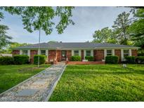 Charming brick home with manicured front yard and unique stone walkway leading to the front door at 3457 W 58Th St, Indianapolis, IN 46228