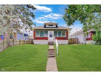 Charming brick home featuring a well-maintained lawn and inviting walkway at 4337 English Ave, Indianapolis, IN 46201
