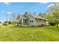 Charming home featuring a covered front porch, well-maintained lawn, and classic architectural details at 4450 N St Rd 39, Danville, IN 46122