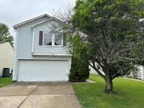 Charming two-story home with vinyl siding, a white garage door, and a well-maintained lawn at 4456 Redcliff N Ln, Plainfield, IN 46168