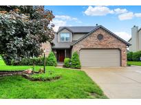 Charming two-story home with a brick accent, tidy lawn, and attached two car garage at 4506 Tarragon Dr, Indianapolis, IN 46237