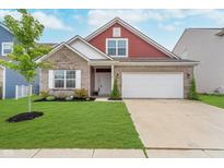Charming two-story home featuring a brick facade, two-car garage and well-manicured lawn at 5304 Maywood Dr, Whitestown, IN 46075