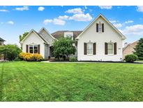 Charming two-story home with manicured lawn, white painted brick, stone accents and beautiful landscaping at 6672 Braemar S Ave, Noblesville, IN 46062