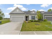 Charming single-story home with gray siding, well-manicured lawn, and attached two-car garage at 7248 Covington St, Lebanon, IN 46052