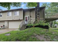 Charming split-level home with a stone chimney and inviting front entrance at 7940 Sunfield Ct, Indianapolis, IN 46214