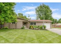 Charming ranch home featuring a well-manicured lawn and an attached garage at 800 E 104Th St, Carmel, IN 46280
