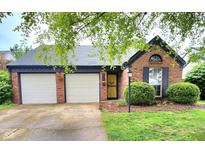 Charming single-story brick home featuring a two-car garage and well-maintained landscaping at 9507 Colony Pointe E Dr, Indianapolis, IN 46250