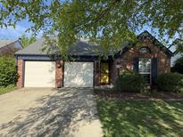 Charming single story brick home with two-car garage and mature landscaping at 9507 Colony Pointe E Dr, Indianapolis, IN 46250