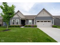 Charming single-story home featuring a well-manicured lawn, inviting curb appeal, and a two-car garage at 9741 Haughton Ln, McCordsville, IN 46055