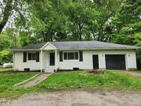 Charming single-story home with a well-maintained yard, front porch, and attached one-car garage at 988 Westfield Rd, Noblesville, IN 46062