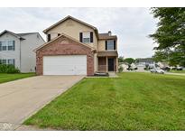 Inviting two-story home with a brick-accented garage and well-manicured lawn at 10722 Mistflower Way, Indianapolis, IN 46235