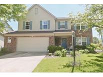 Charming two-story home with a brick facade, attached garage, and well-manicured lawn at 12677 Honors Dr, Carmel, IN 46033