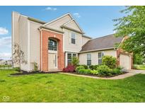 Charming two-story home featuring a manicured lawn and brick accents at 14036 Rayners Ln, Fishers, IN 46037