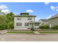 Charming two-story home with green accents, covered porch, and a well-maintained front yard at 236 W 33Rd St, Indianapolis, IN 46208